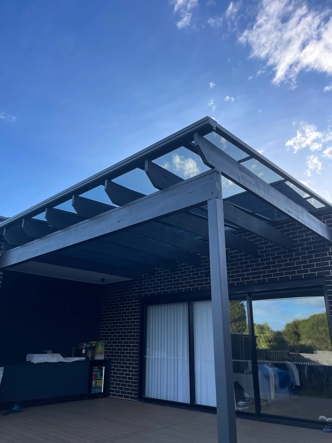 Clearview transparent roofing installed above a retained timber pergola