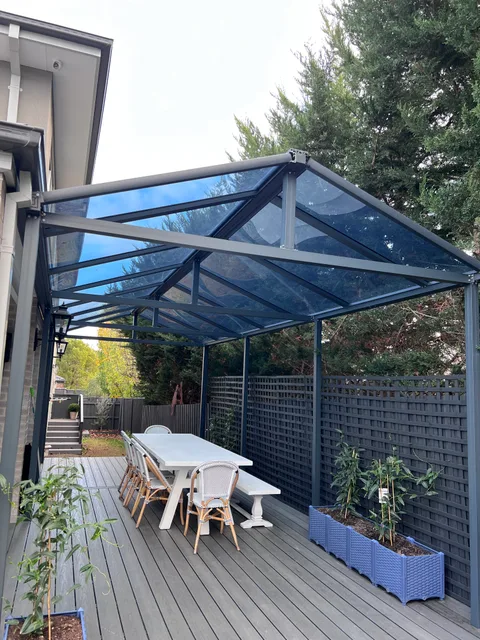 Clearview installation: Pitched roof over an outdoor dining area
