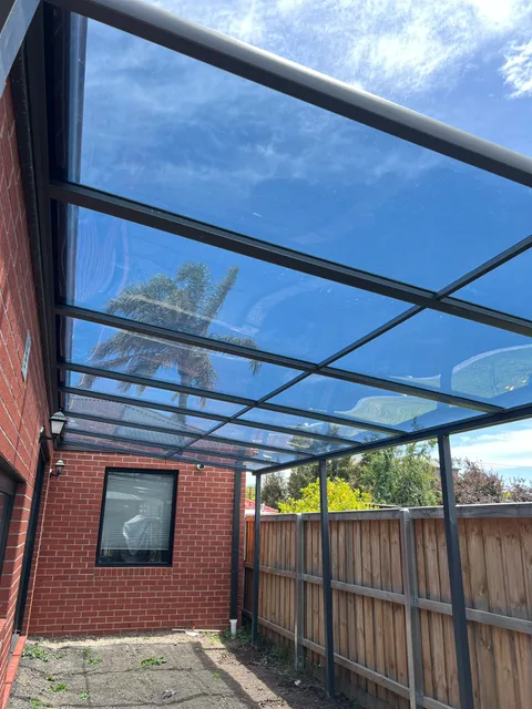 Clearview installation: Patio cover beside a brick home